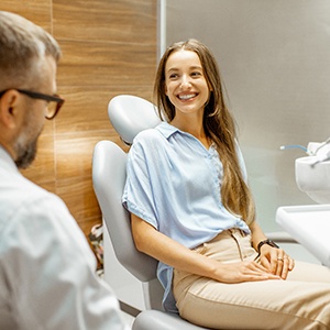 A young woman consulting with her dentist about treatment