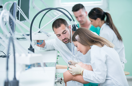 Multiple dentists treating their patients