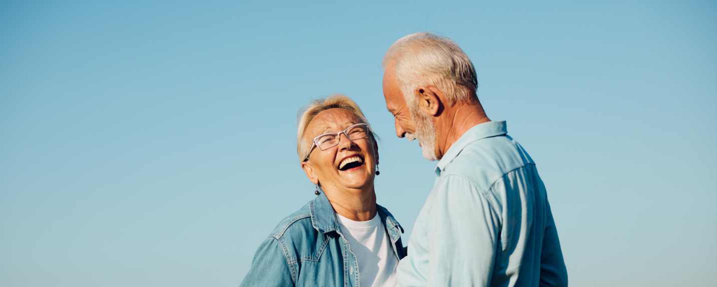 Senior man and woman smiling at each other