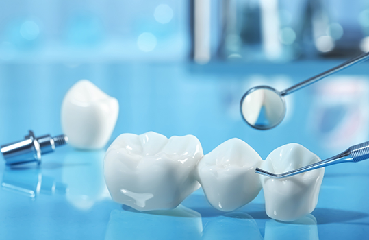 Close up of dental instruments and dental bridge