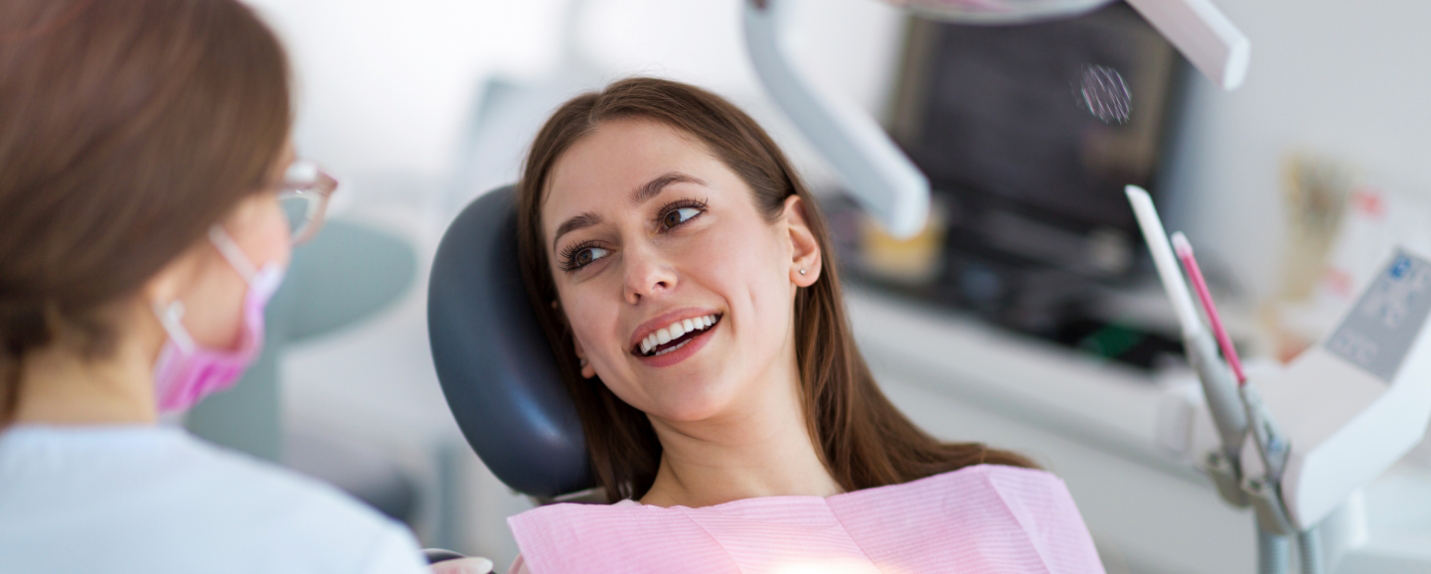 Female dental patient smiling at dentist