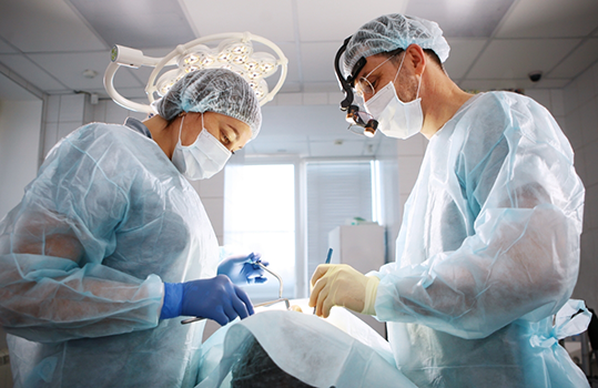 Two dentists performing wisdom tooth extraction in Montague