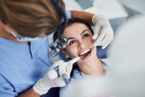 a smiling patient receiving a dental treatment