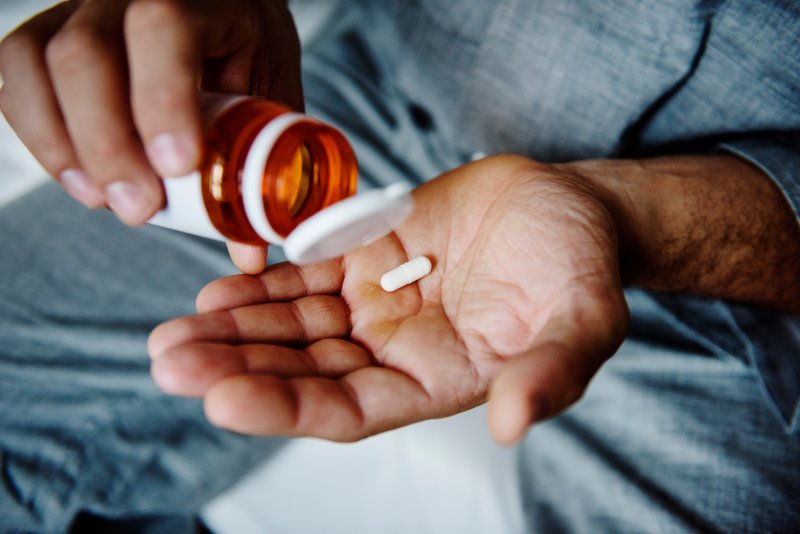 A man taking a pain medication